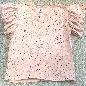 Pink kids shirt with black splatter design.